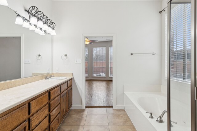 full bathroom with tiled shower / bath combo, vanity, tile patterned floors, and toilet