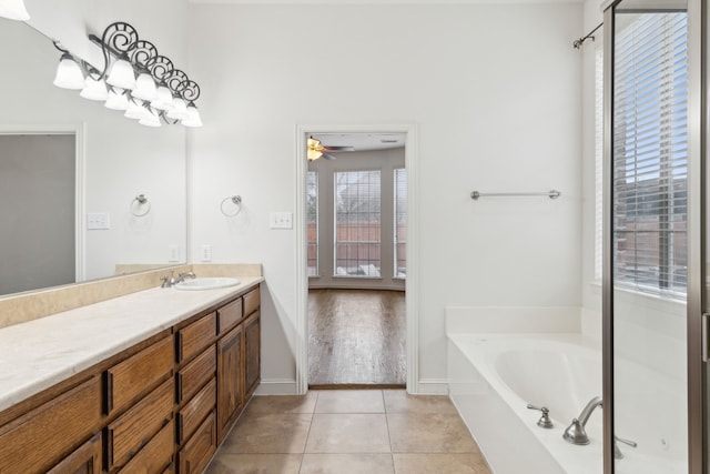 bathroom with vanity, a tub, tile patterned floors, and ceiling fan