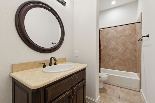 full bathroom featuring tile patterned floors, vanity, toilet, and tiled shower / bath combo