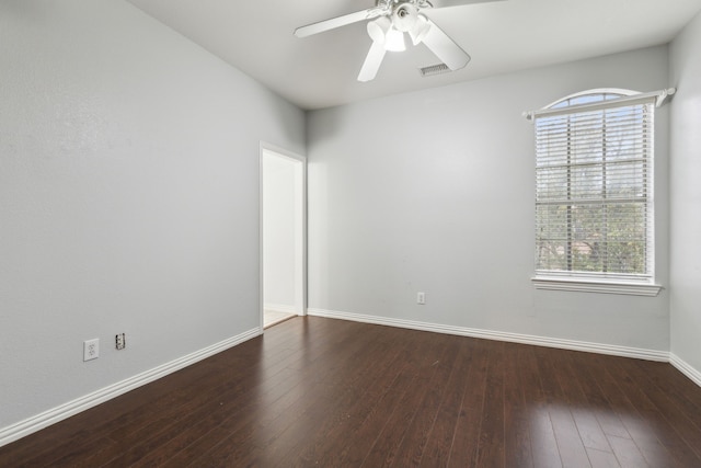 spare room featuring dark wood-type flooring and ceiling fan