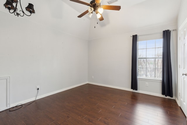 spare room with dark wood-type flooring, ceiling fan, and vaulted ceiling