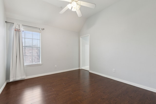 spare room with vaulted ceiling, dark hardwood / wood-style floors, and ceiling fan