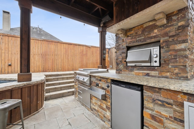 view of patio / terrace featuring exterior kitchen and area for grilling