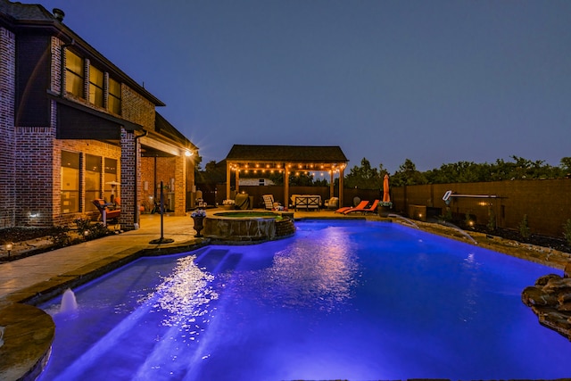 view of pool featuring a gazebo, pool water feature, an in ground hot tub, and a patio