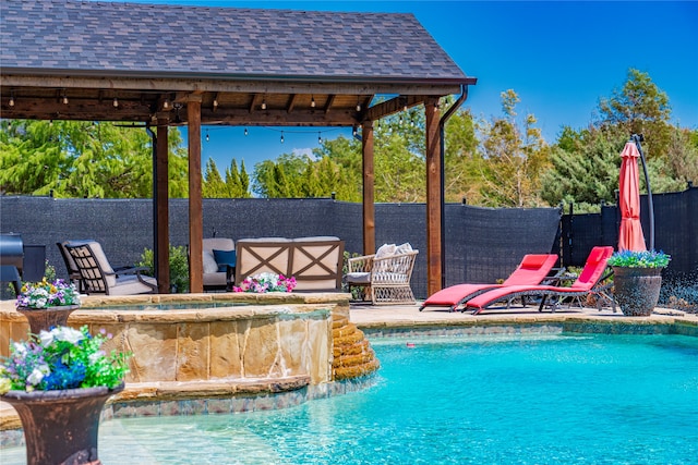 view of swimming pool with a gazebo and pool water feature