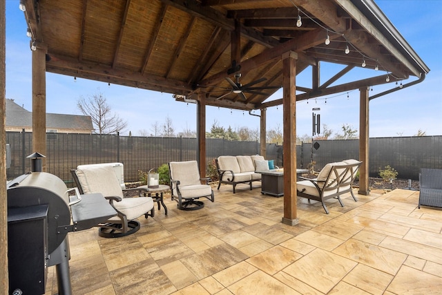 view of patio / terrace with a gazebo, a grill, an outdoor living space with a fire pit, and ceiling fan