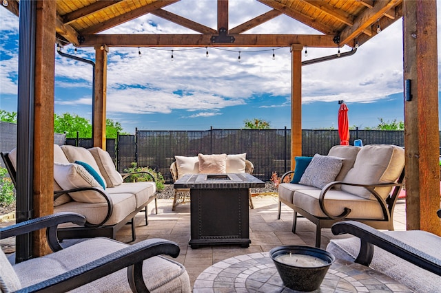 view of patio with a gazebo and an outdoor living space with a fire pit