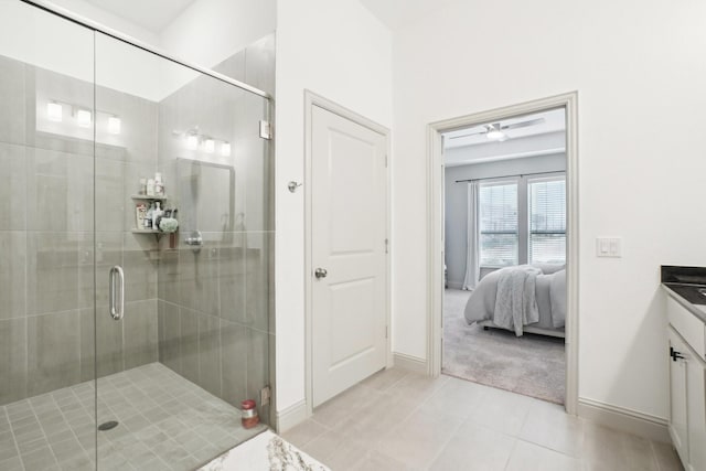 bathroom featuring tile patterned flooring, vanity, and an enclosed shower