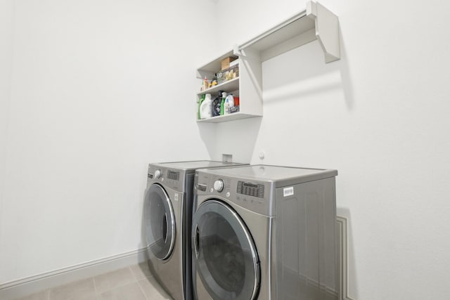 laundry room featuring separate washer and dryer and light tile patterned floors