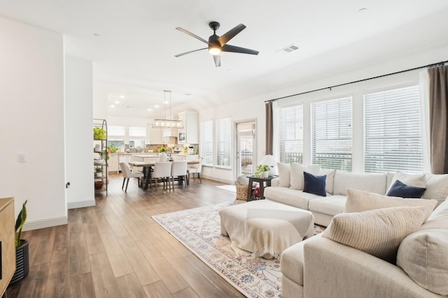 living room featuring ceiling fan and wood-type flooring