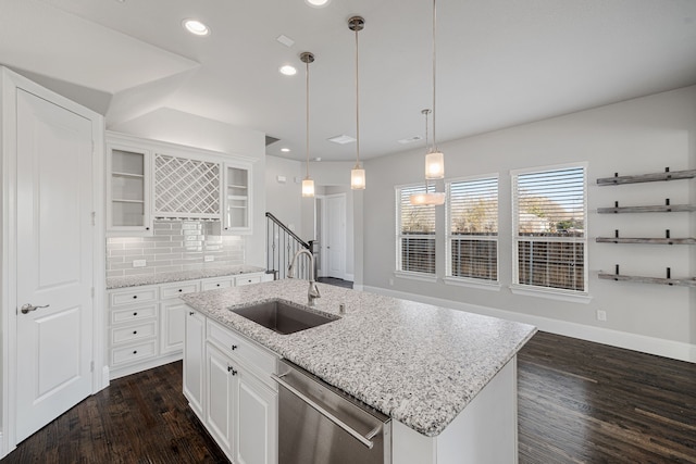 kitchen with sink, white cabinetry, stainless steel dishwasher, an island with sink, and pendant lighting