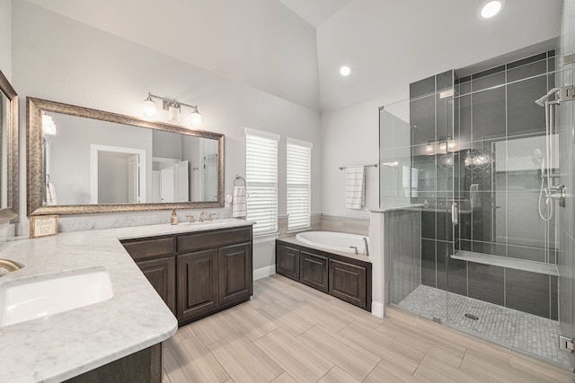 bathroom featuring vanity, lofted ceiling, and plus walk in shower