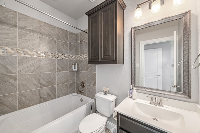 full bathroom with vanity, tiled shower / bath combo, and toilet