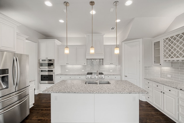 kitchen with white cabinetry, an island with sink, and appliances with stainless steel finishes