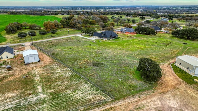 birds eye view of property with a rural view