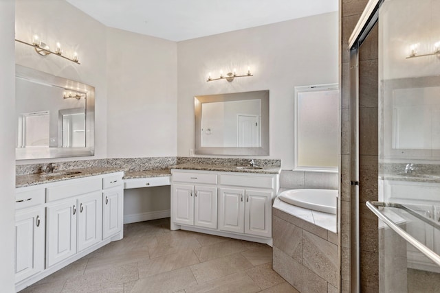 bathroom featuring vanity and tiled tub