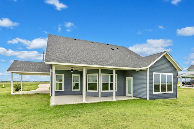 rear view of house featuring a lawn and a patio