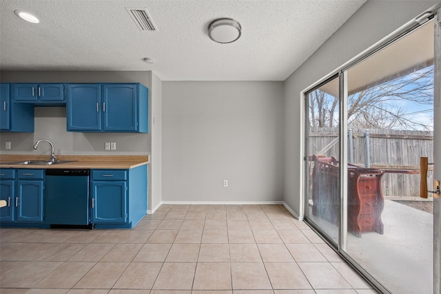 kitchen featuring sink, light tile patterned floors, dishwasher, a textured ceiling, and blue cabinets