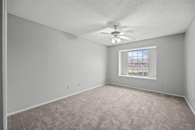 carpeted empty room featuring a textured ceiling and ceiling fan