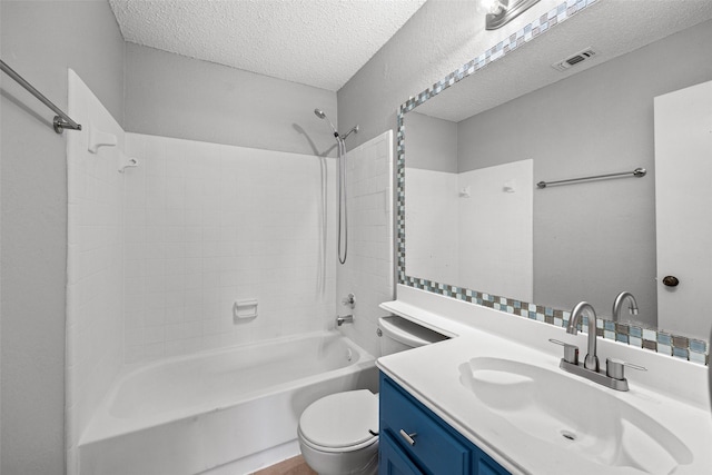 full bathroom with shower / washtub combination, toilet, a textured ceiling, and vanity