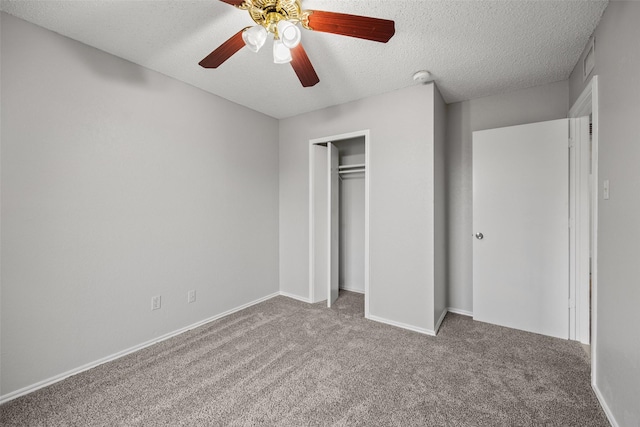 unfurnished bedroom featuring ceiling fan, light colored carpet, a closet, and a textured ceiling