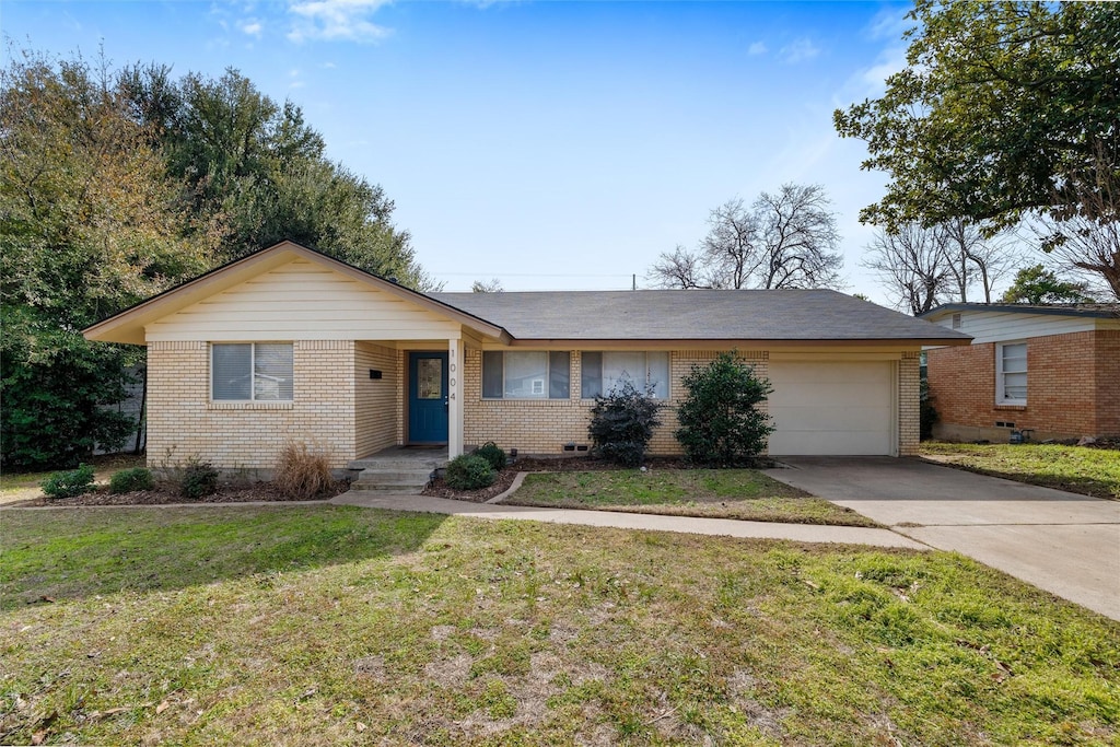 ranch-style house featuring a garage and a front lawn