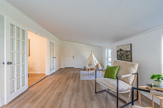 sitting room with hardwood / wood-style floors and french doors