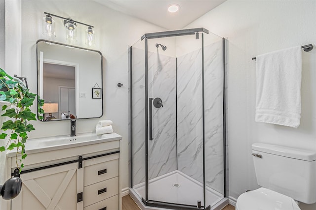 bathroom featuring vanity, toilet, and walk in shower