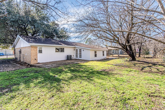 back of property featuring central AC unit, a yard, a patio area, and french doors