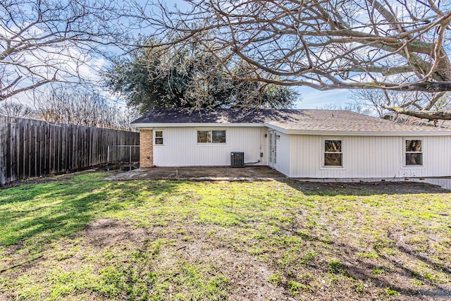 back of house with a patio area and a lawn