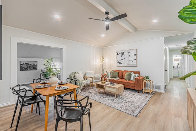 living room with vaulted ceiling with beams, ceiling fan, and light wood-type flooring