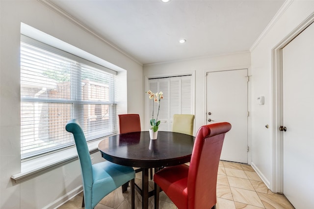 tiled dining room featuring ornamental molding