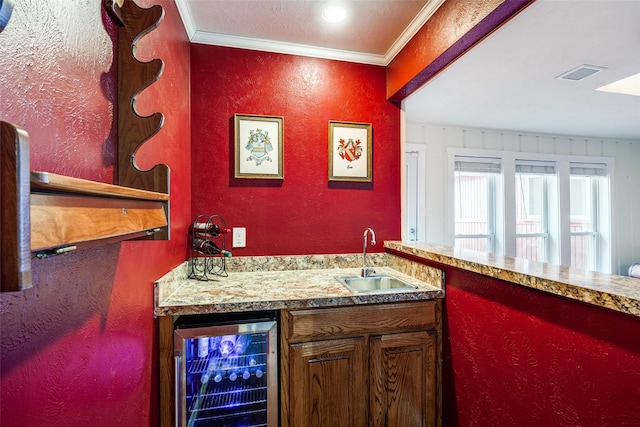 bar with wine cooler, sink, and ornamental molding