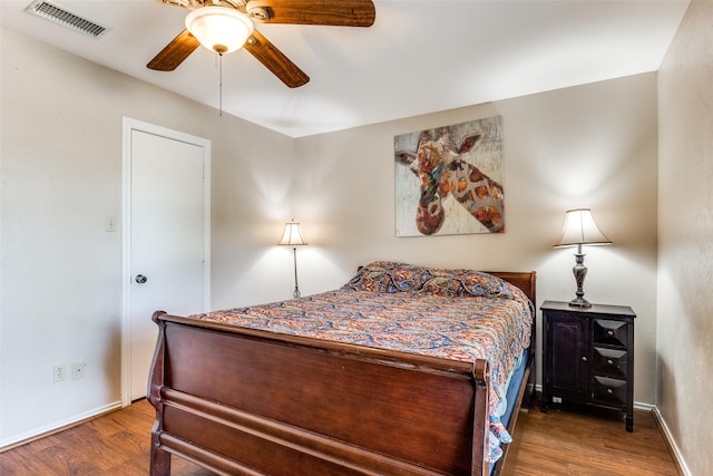 bedroom featuring dark hardwood / wood-style flooring and ceiling fan