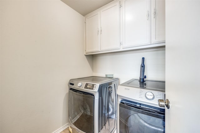 laundry area featuring cabinets and washer and dryer