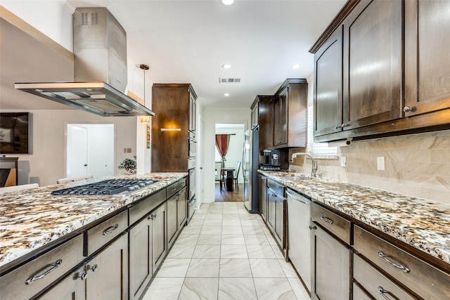 kitchen featuring sink, light stone counters, dark brown cabinets, appliances with stainless steel finishes, and island exhaust hood