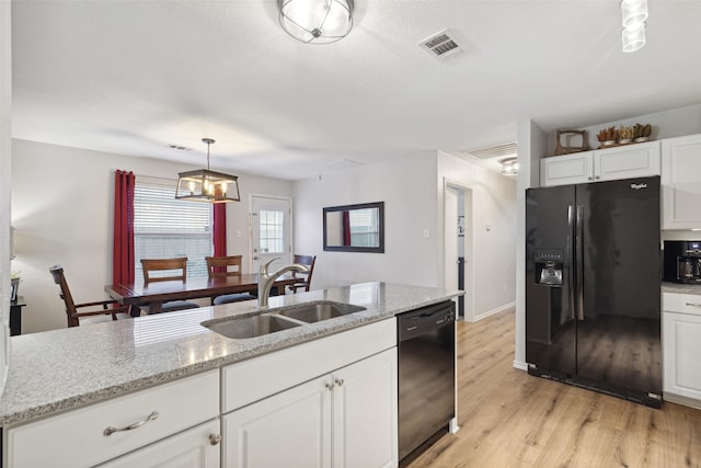 kitchen featuring sink, light hardwood / wood-style flooring, black appliances, white cabinets, and decorative light fixtures