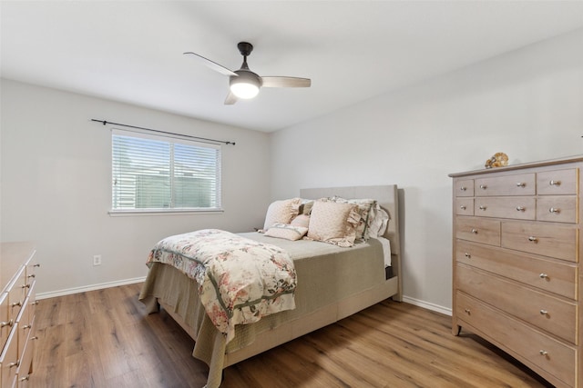 bedroom with light hardwood / wood-style floors and ceiling fan