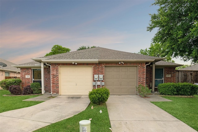 ranch-style home with a yard and a garage