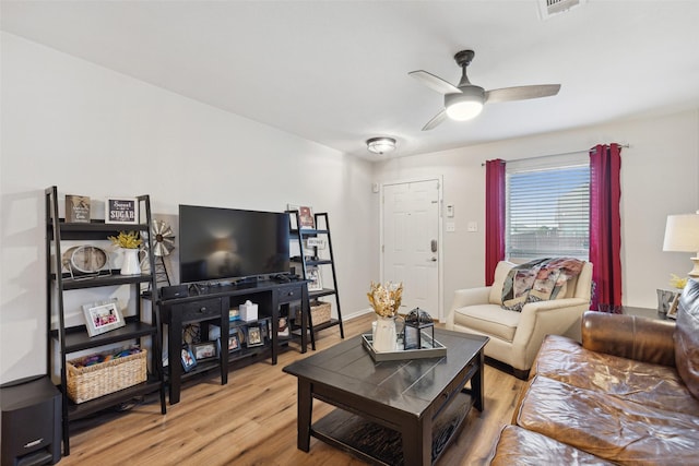 living room featuring ceiling fan and light hardwood / wood-style floors