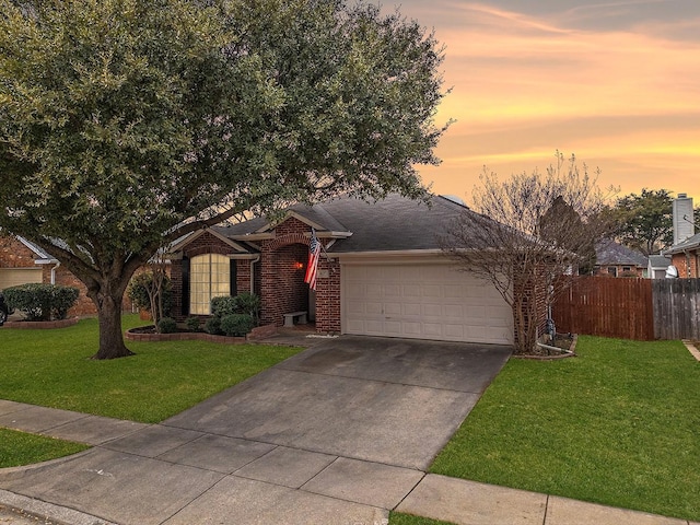 ranch-style house with a garage and a lawn