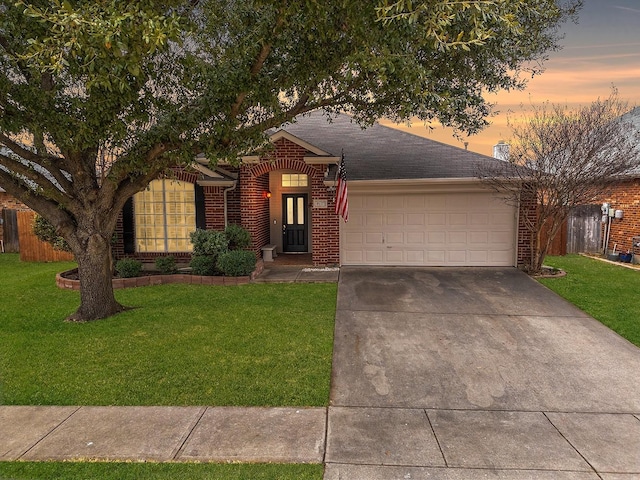 view of front of house featuring a garage and a lawn