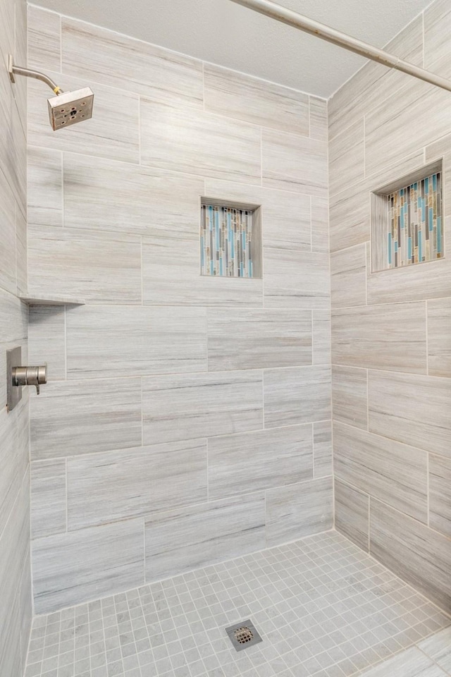 bathroom with a tile shower