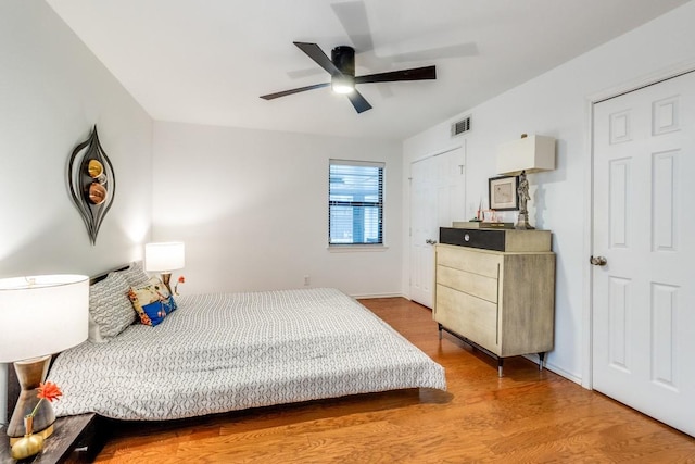 bedroom with ceiling fan and wood-type flooring