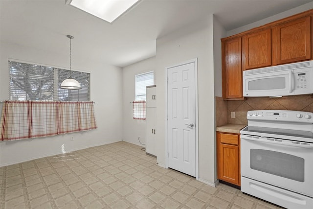 kitchen with hanging light fixtures, backsplash, and white appliances