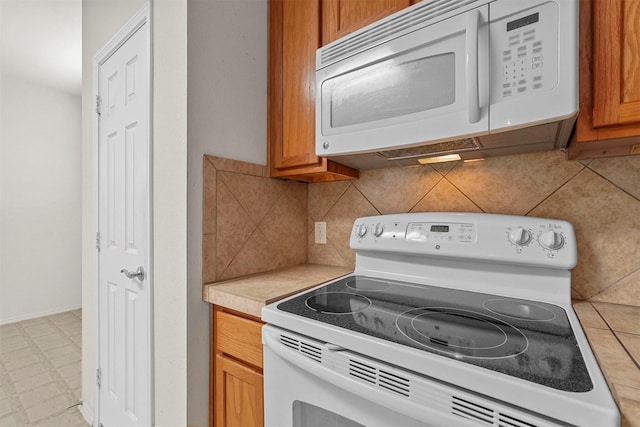 kitchen with white appliances and backsplash