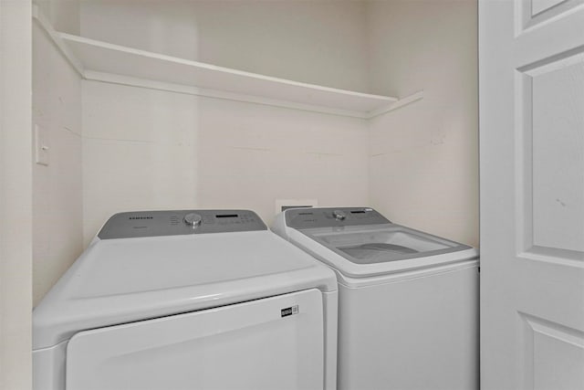 clothes washing area with independent washer and dryer