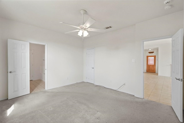 carpeted spare room featuring ceiling fan