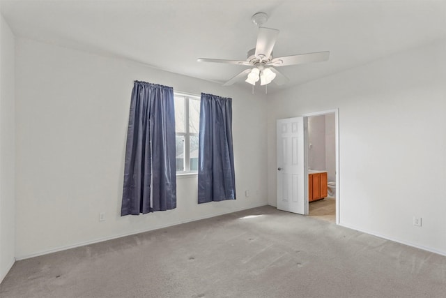 unfurnished room with light colored carpet and ceiling fan