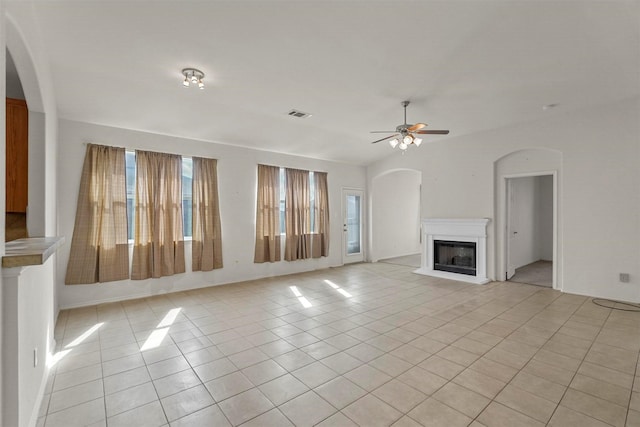 unfurnished living room with light tile patterned floors and ceiling fan